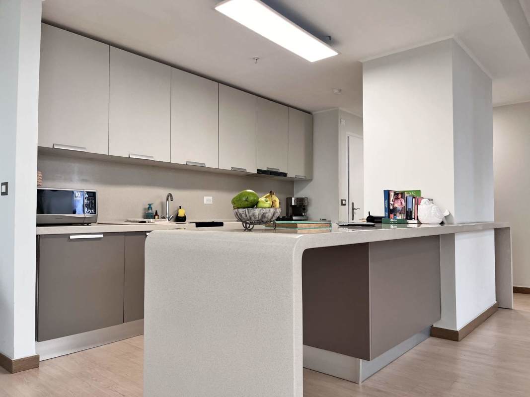 Elegant lobby with wood walls, pendant lights, seating area in PH Quartier del Mar Panama City