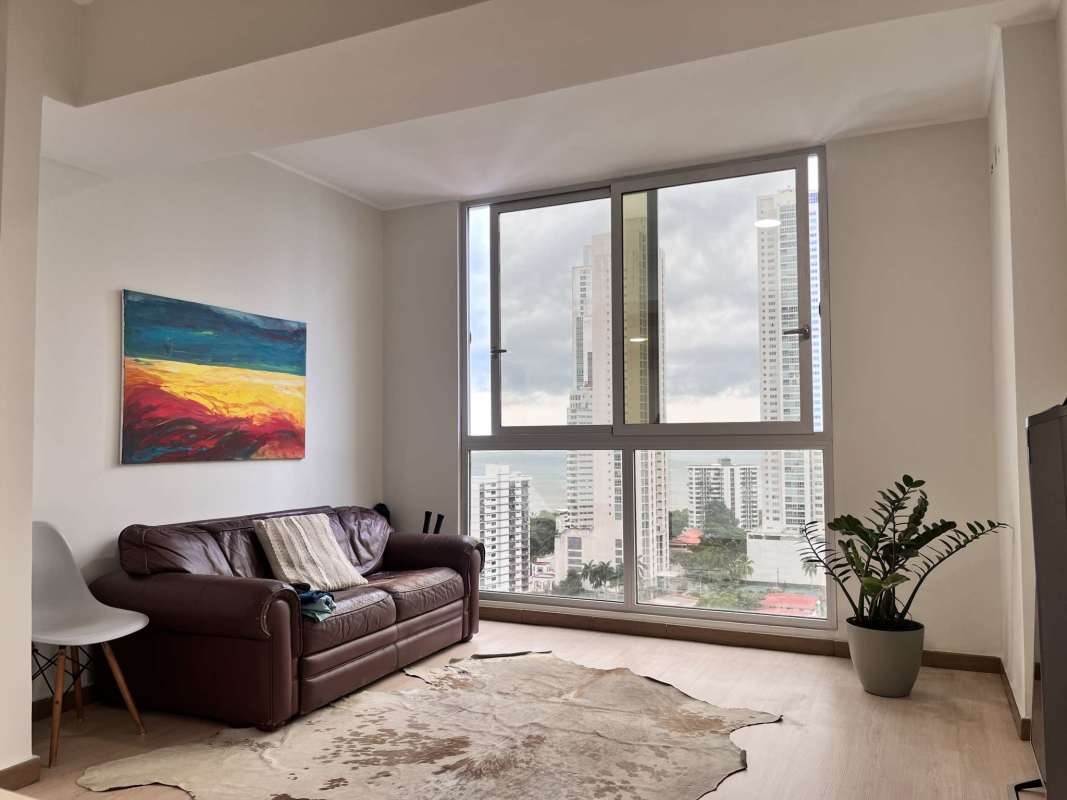 Contemporary living room with large windows and Panama city skyline view in PH Quartier del Mar