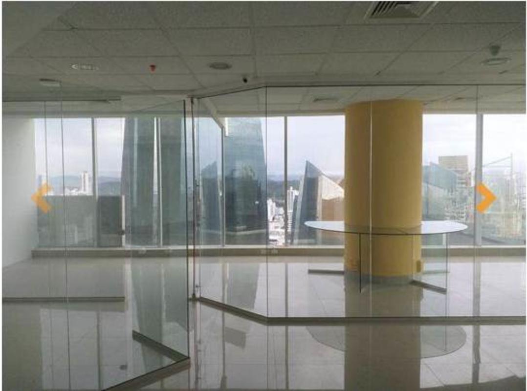 Open-plan office interior with glass partitions, panoramic city view in F&F Tower Panama City