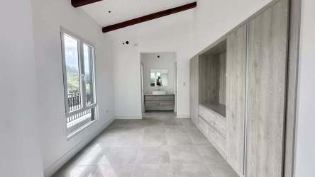 Bright bedroom with large windows, ocean scenery, exposed beams Blue Venao Panama