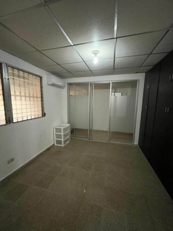 Bedroom with sliding glass closet, AC unit, window security grill in Linda Vista neighborhood Panama City