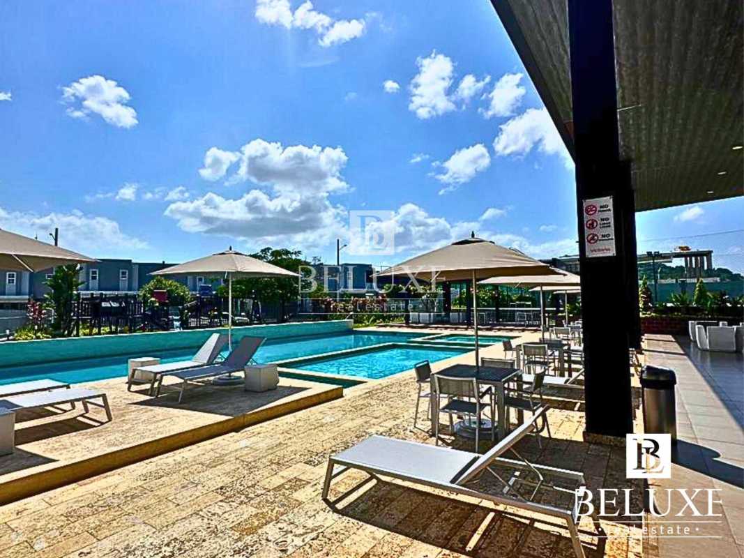 Modern outdoor swimming pool with lounge chairs shaded in PH Augusta Panama