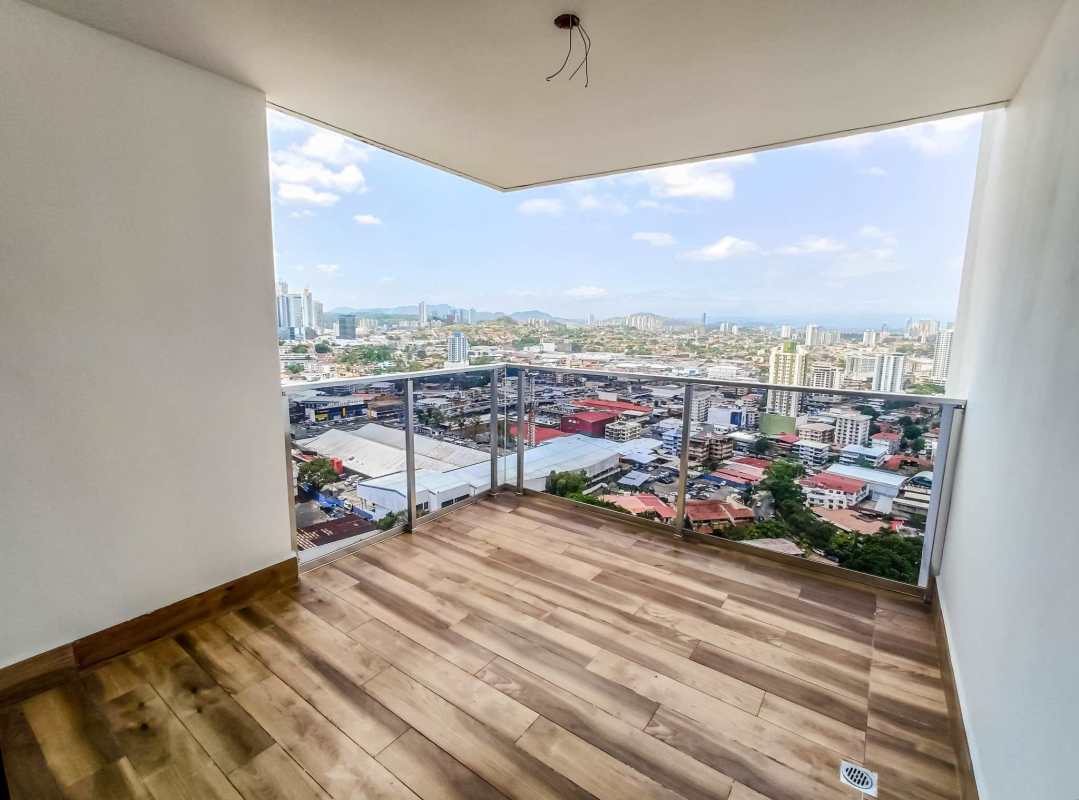 L-shaped kitchen with granite countertop, wood cabinets and window PH Carreras Tower El Cangrejo Panama