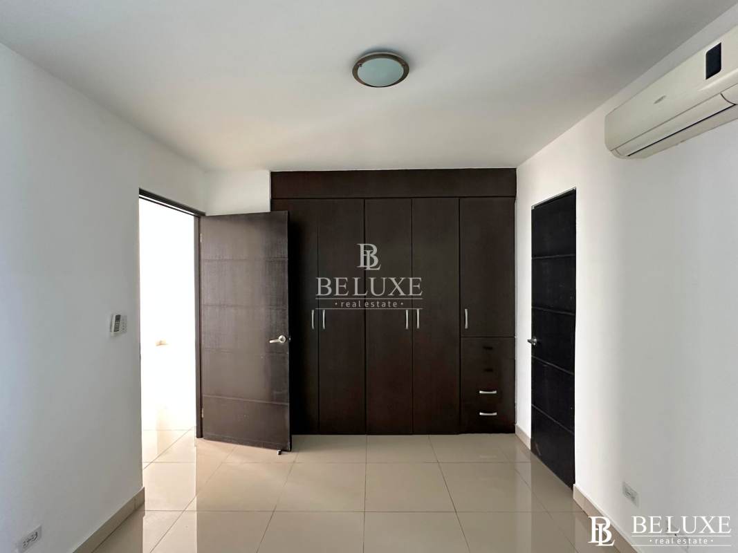 Bright bedroom with built-in closet and city ocean views Serenity at the Bay Panama