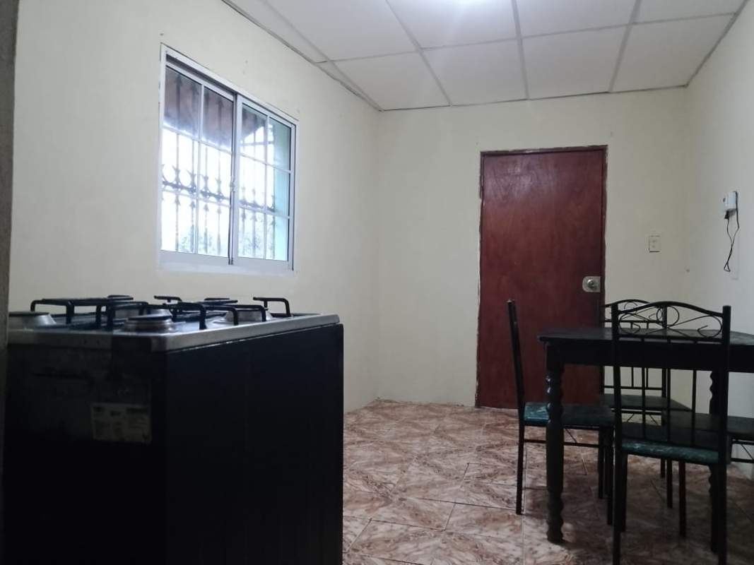 Dining table with chairs and sunlight window in Villa Lobos Pedregal Panama apartment