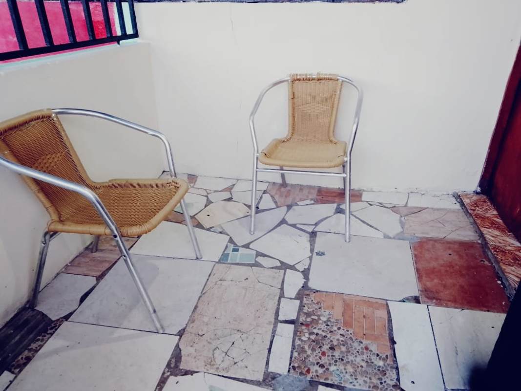 Patio with mosaic floor and chairs in Villa Lobos Pedregal apartment Panama