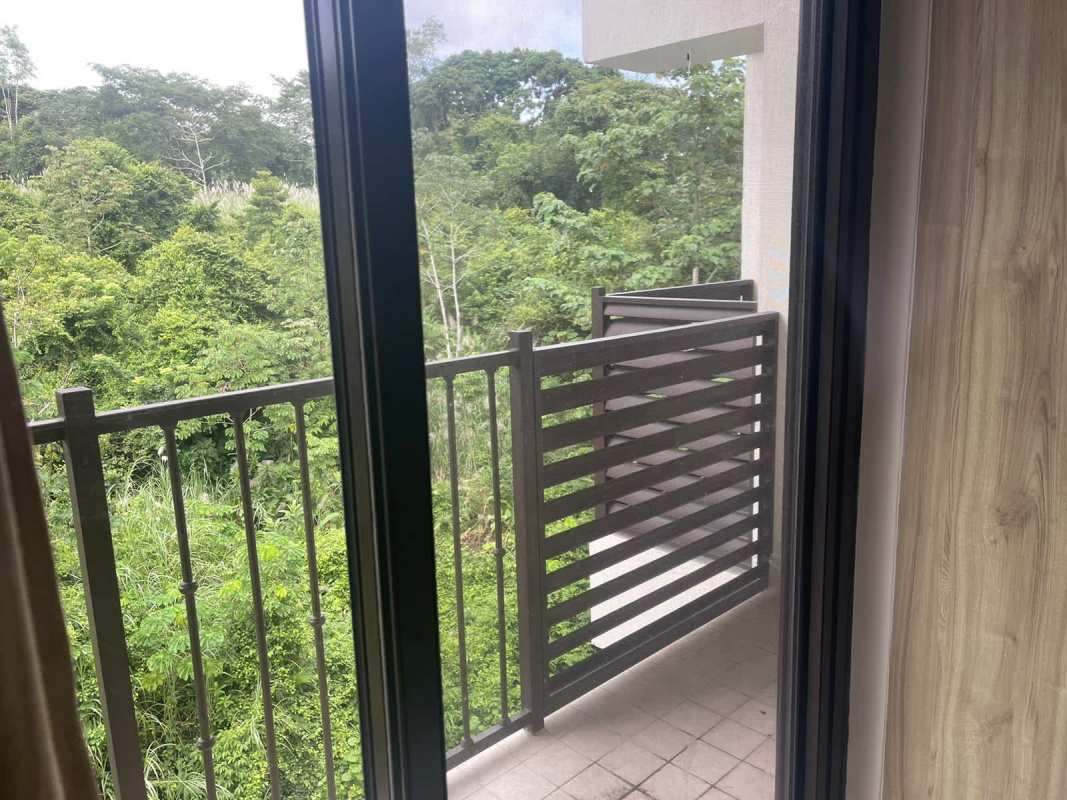 Second bedroom with balcony and forest scenery PH Embassy Village Clayton Panama