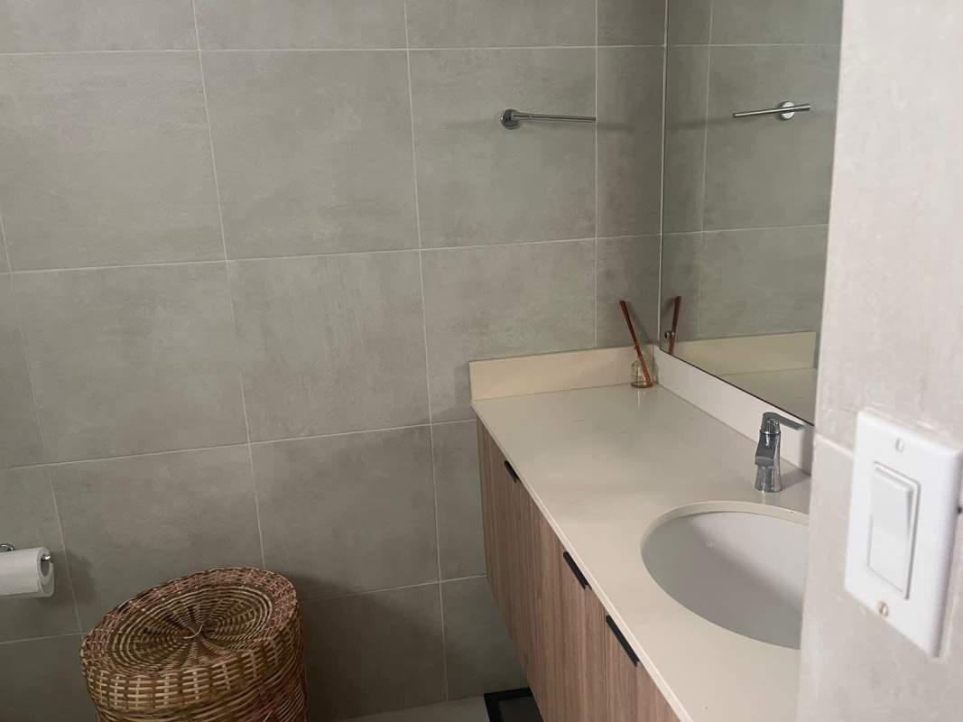 Modern kitchen with granite countertop island, dining space, and ample storage PH Embassy Village Panama