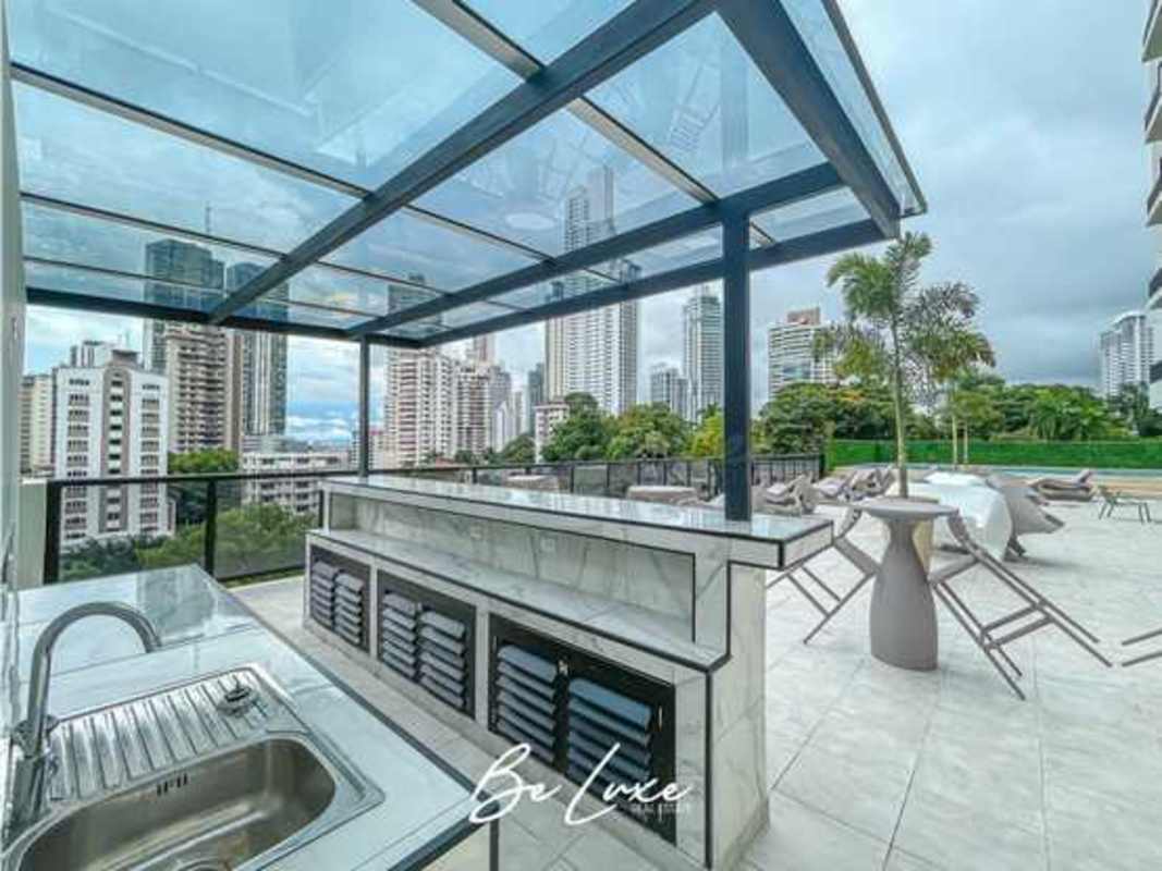 Outdoor lounge and BBQ area with skyline view at PH The Gray Obarrio Panama City