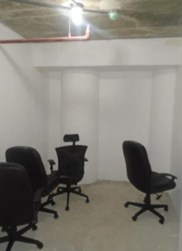 Unfinished small meeting office with exposed concrete and simple chairs in PH Los Colores de Bella Vista