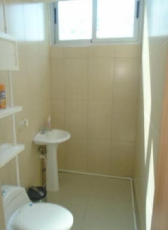 Small bathroom with beige tiles pedestal sink and shelves in PH Los Colores de Bella Vista Panama