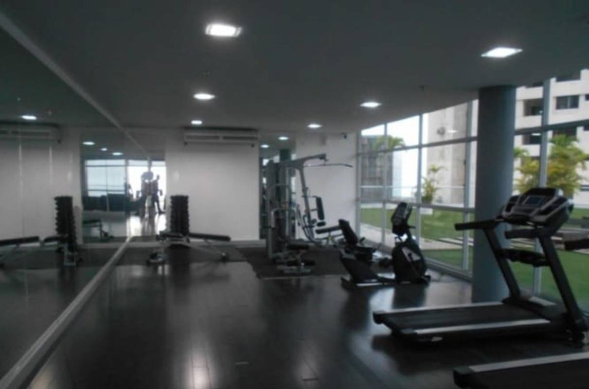 Modern gym with cardio equipment, mirror walls, large windows in PH Los Colores Bella Vista Panama City