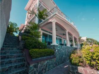 Exterior facade of Mediterranean beachfront boutique hotel with balconies in San Carlos Panama