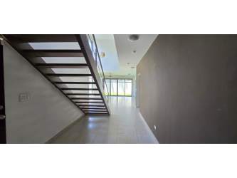 Hallway with floating wooden stairs modern glass sliders bright design Nativa Panama Pacifico