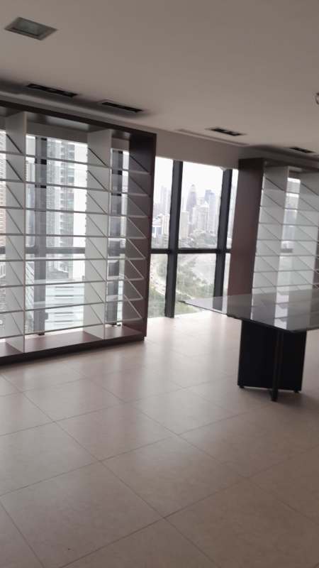 Modern executive corporate office space divided with glass walls in PH Torre BAC overlooking the Panama skyline