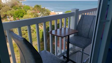 Living and dining room fully furnished overlooking ocean and green landscape PH Ibiza Playa Corona Panama