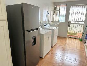 Bedroom with porcelain tiles, ceiling fan and AC at Residencial Howard Panama house rental