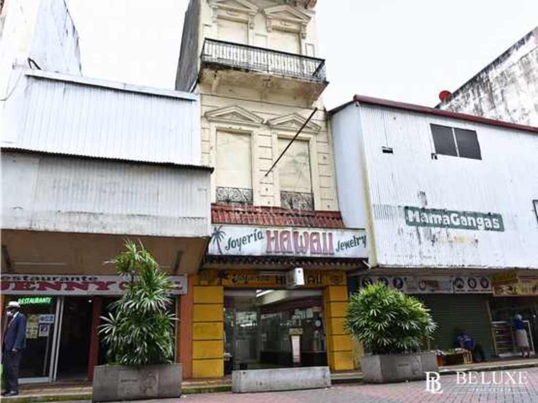 Exterior street view of commercial property with large display windows and colonial facade on Avenida Central Santa Ana Panama City