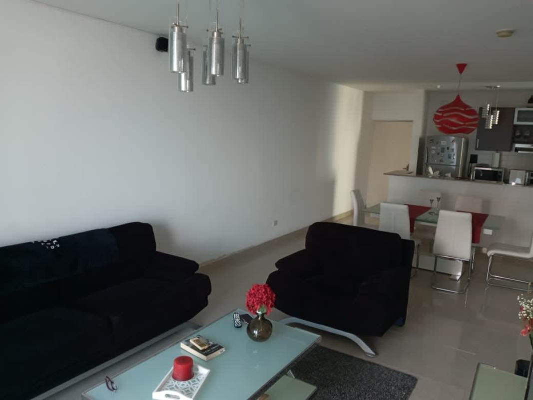 Cozy bedroom with mounted TV, city view, and modern decor in PH Pacific Sky