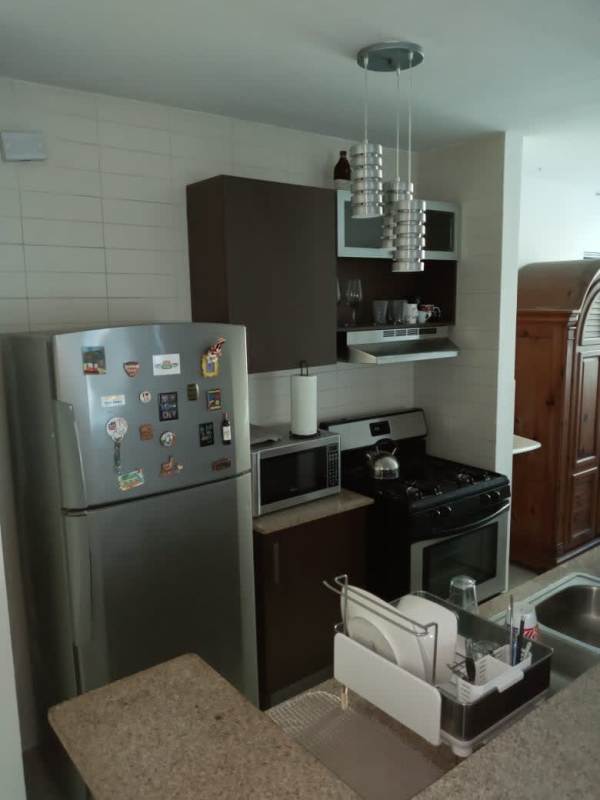 Kitchen with stainless appliances, granite countertops in PH Pacific Sky