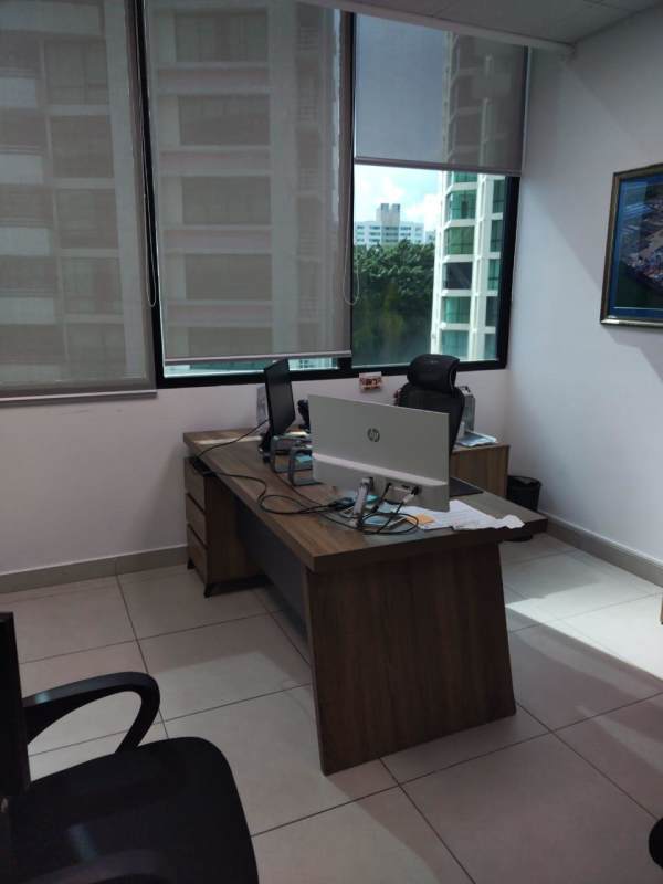 Private office area with large window, desk, and city view at Edison Park Panama