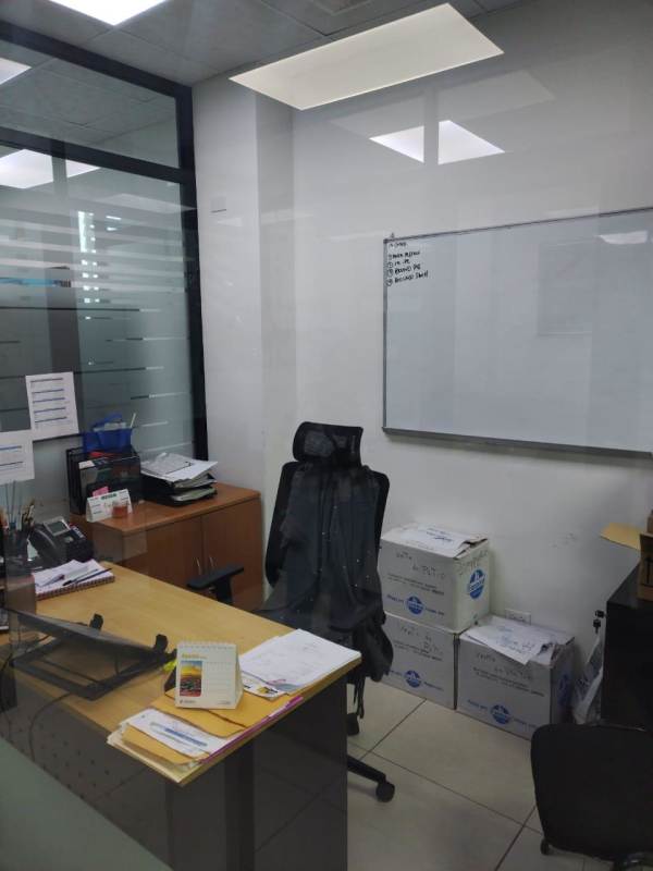 Modern conference room with glass walls and wooden table in PH Edison Corporate Panama City