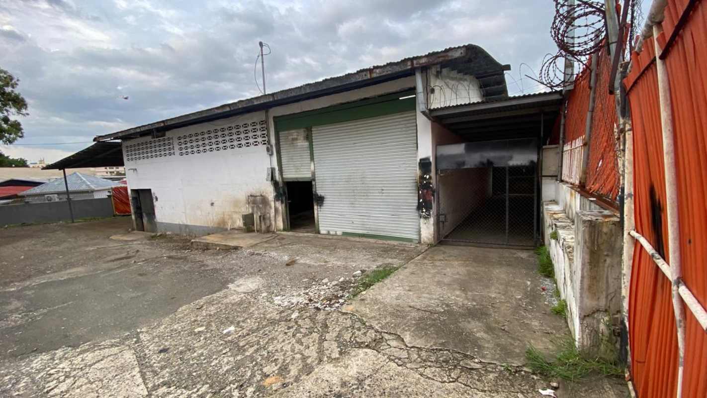 Warehouse exterior with rolling metal doors and fenced yard Parque Lefevre Panama