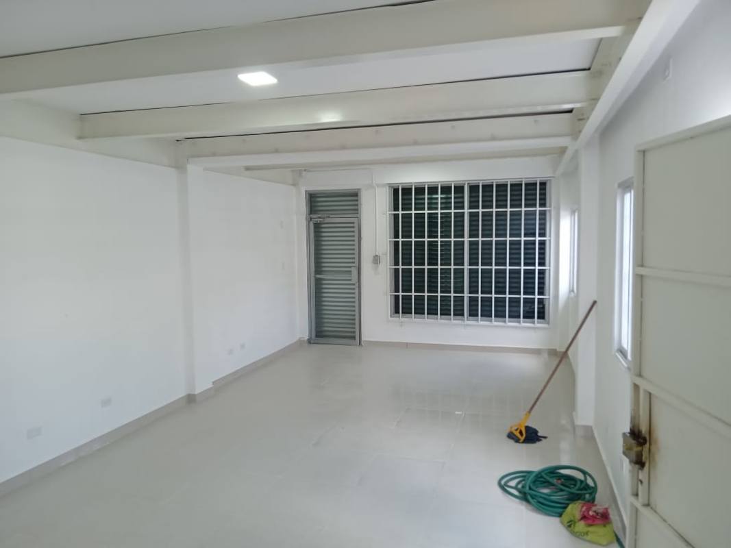 Spacious utility or storage room with metal door and window in Vista Hermosa commercial office Panama