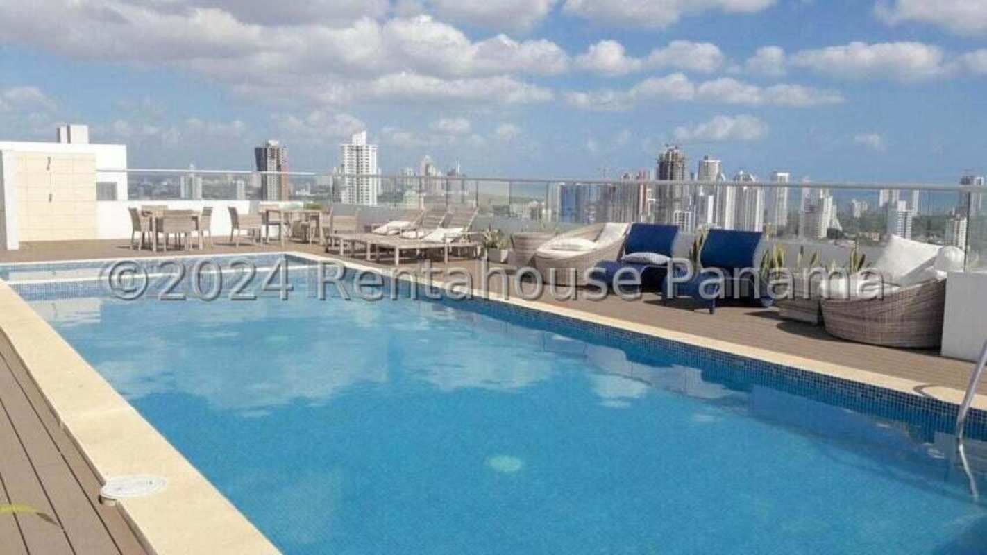 Rooftop pool deck with lounge chairs and city skyline views at PH Majestic Gardens Edison Park Panama
