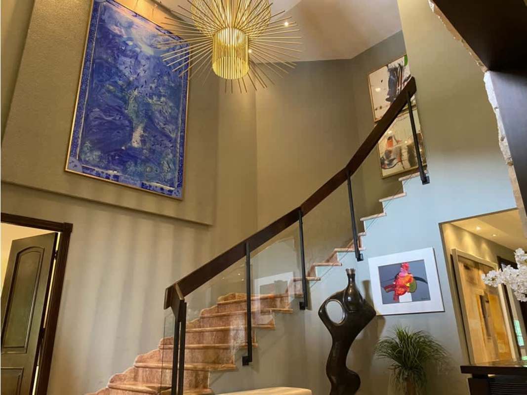 Spacious kitchen with marble island, stainless appliances, pendant lighting in luxury Costa del Este house