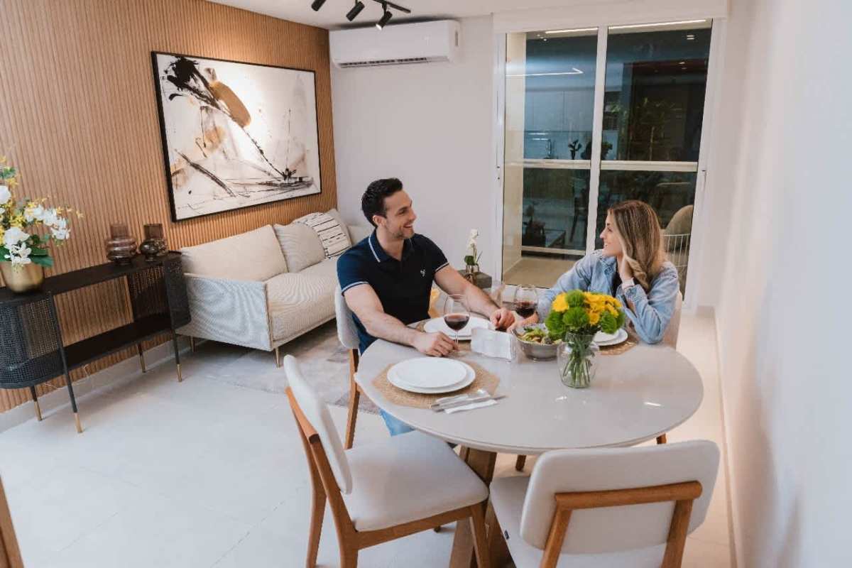 Dining table next to modern kitchen with island in PH Mi Condado Condado del Rey Panama