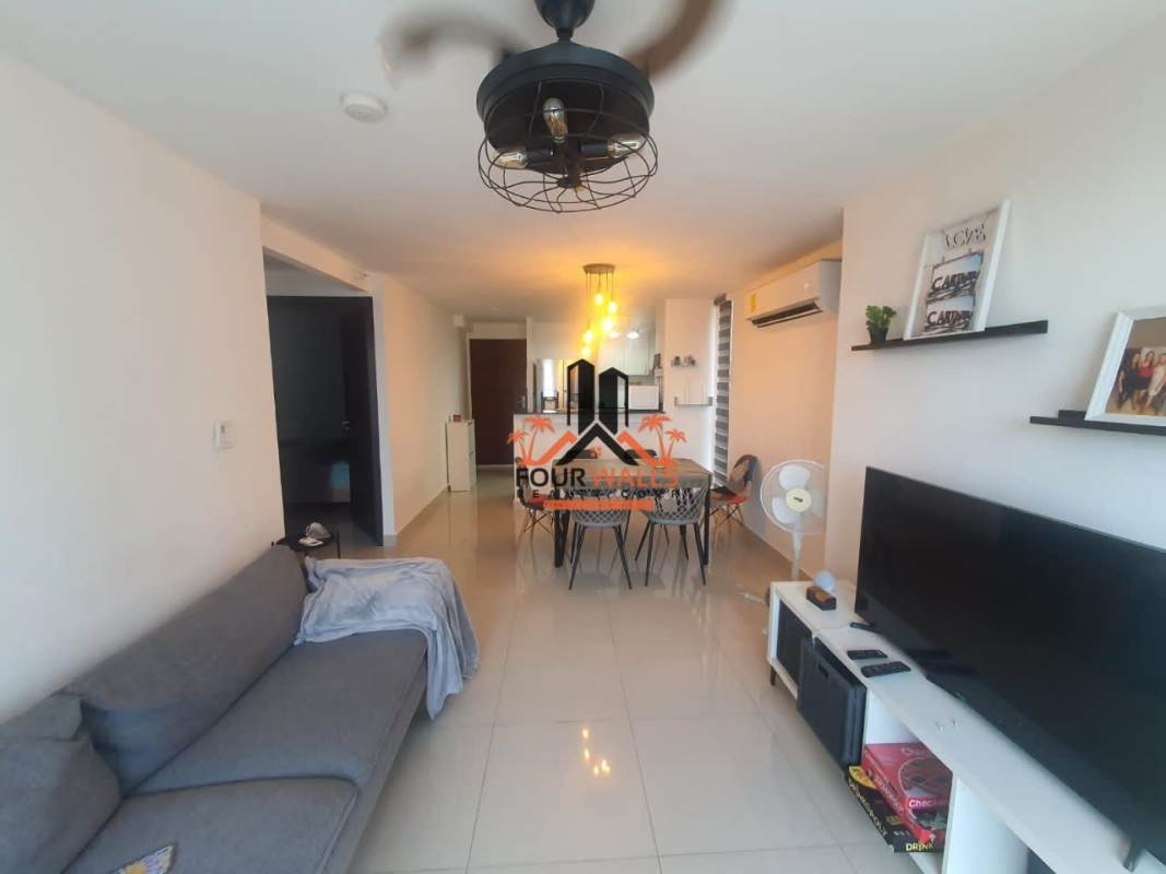 Bright bedroom with large windows offering city skyline views at PH Park Point Panama City