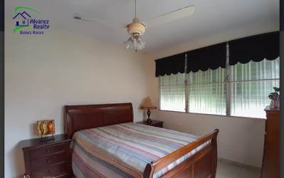 Spacious master bedroom with large closet, neutral décor, ceiling fan in David Chiriquí Panama