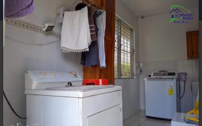 Laundry area with washer dryer hookups, storage cabinets in family house Panama
