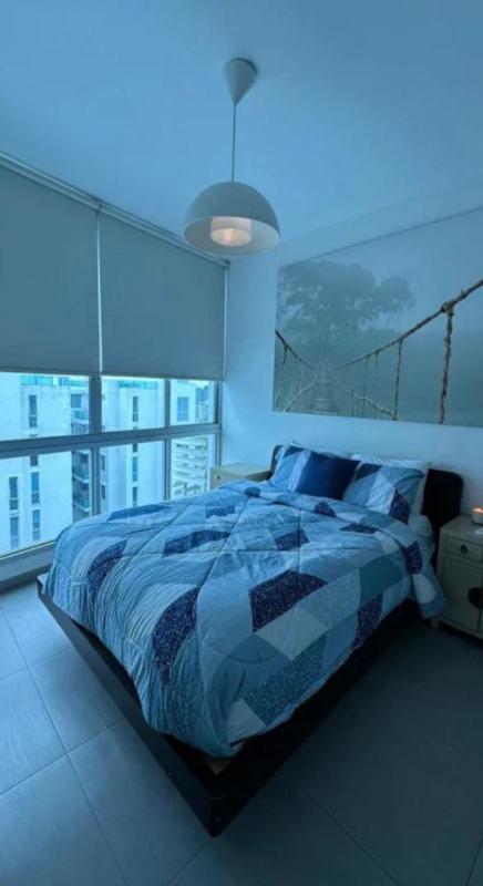Modern bedroom with queen bed, pendant lights and city view in PH Marina Park Panama
