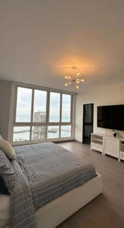 Bright living room with entertainment wall and floor to ceiling window PH Marina Park Panama