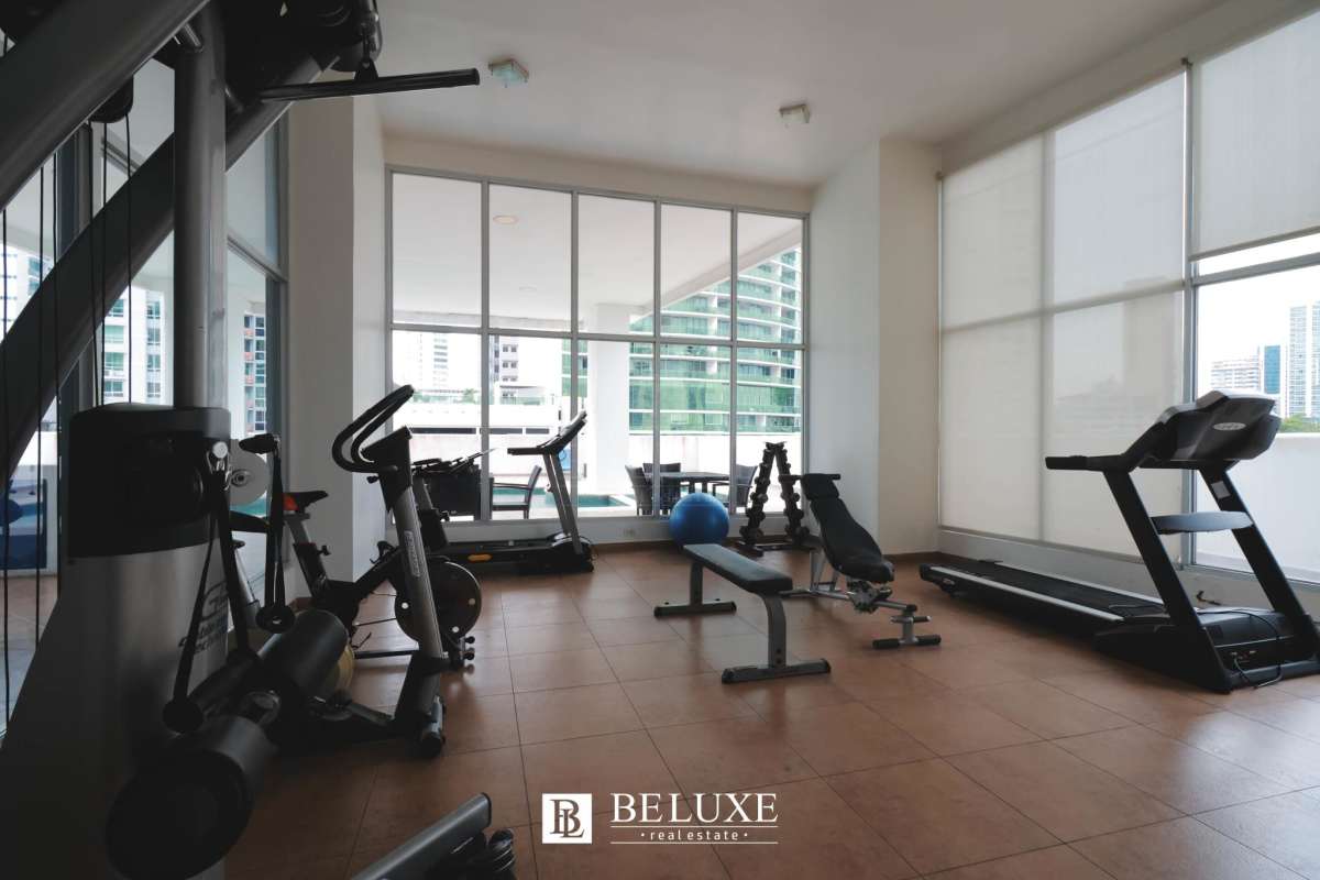 Modern gym with fitness equipment and city skyline backdrop PH Marina Park Panama