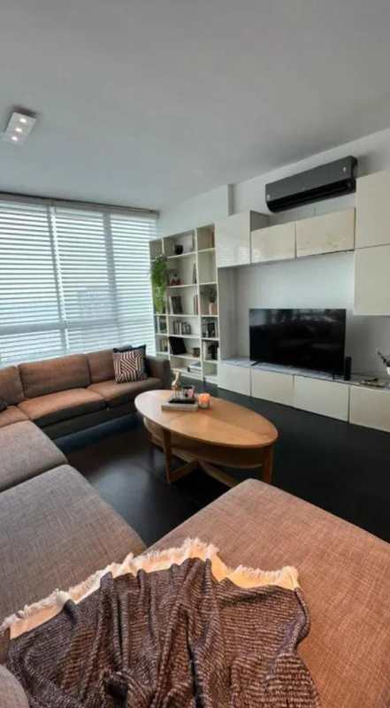 Living room with sectional sofa, coffee table, TV and blinds PH Marina Park Panama