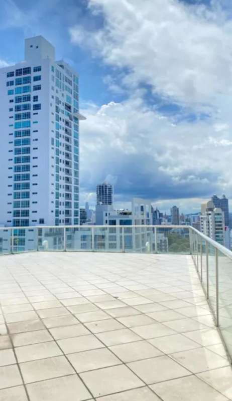 Large rooftop terrace with glass railing city view PH Marina Park Panama
