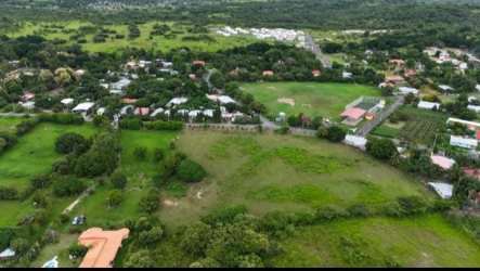 Aerial perspective of large open flat land with nearby residences in Chame Panama