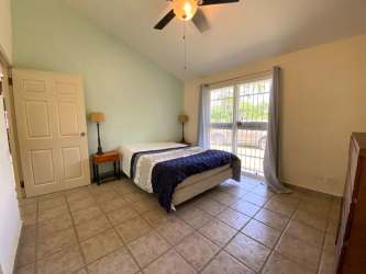 Bedroom with tile floor, large window, ceiling fan Club Ecuestre Coronado Panama