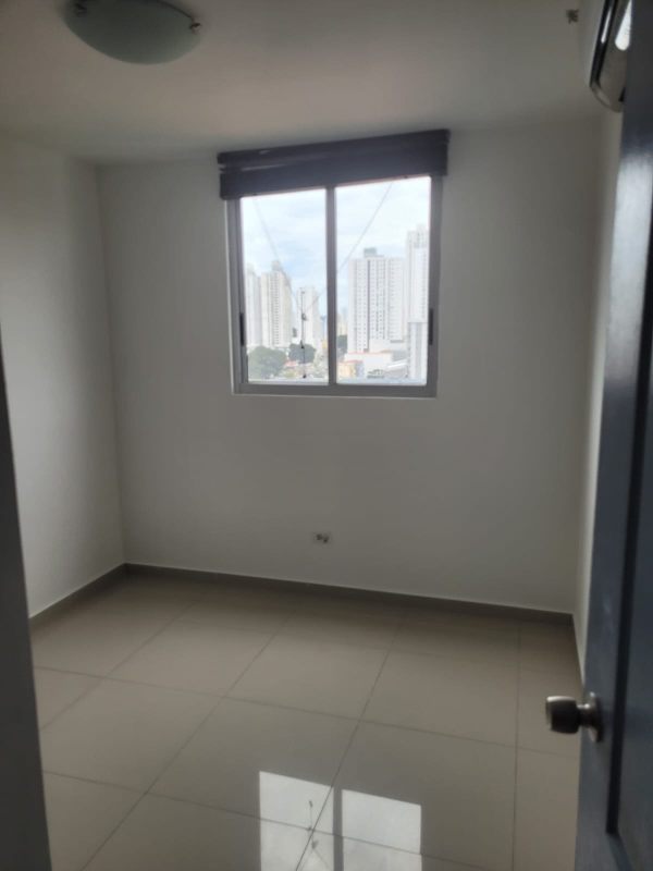 Empty bedroom with large window and tiled floors, city views PH City Tower Panama