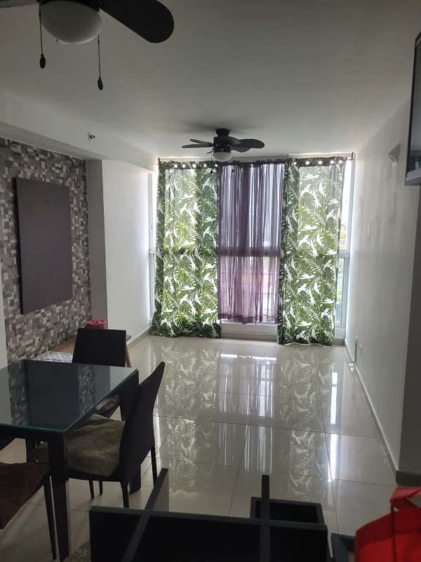 Modern living dining area with ceiling fan, large windows and city views in PH City Tower Panama City