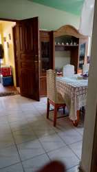Dining area with tiled floors, wood ceiling, and large windows in rental house David Panama