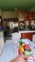 Traditional dining area with wooden furniture, china cabinet and tile floors in Panama house rental
