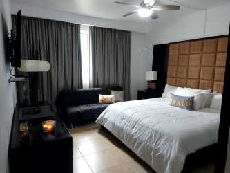 Open kitchen with appliances and granite countertops Nikki Residences Playa Blanca Panama