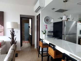 Spacious master bedroom with ocean views balcony and king bed in Nikki Residences Playa Blanca