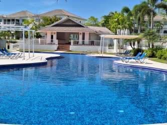 Furnished master bedroom with garden views at Bijao Gailard Condo in Playa Panama