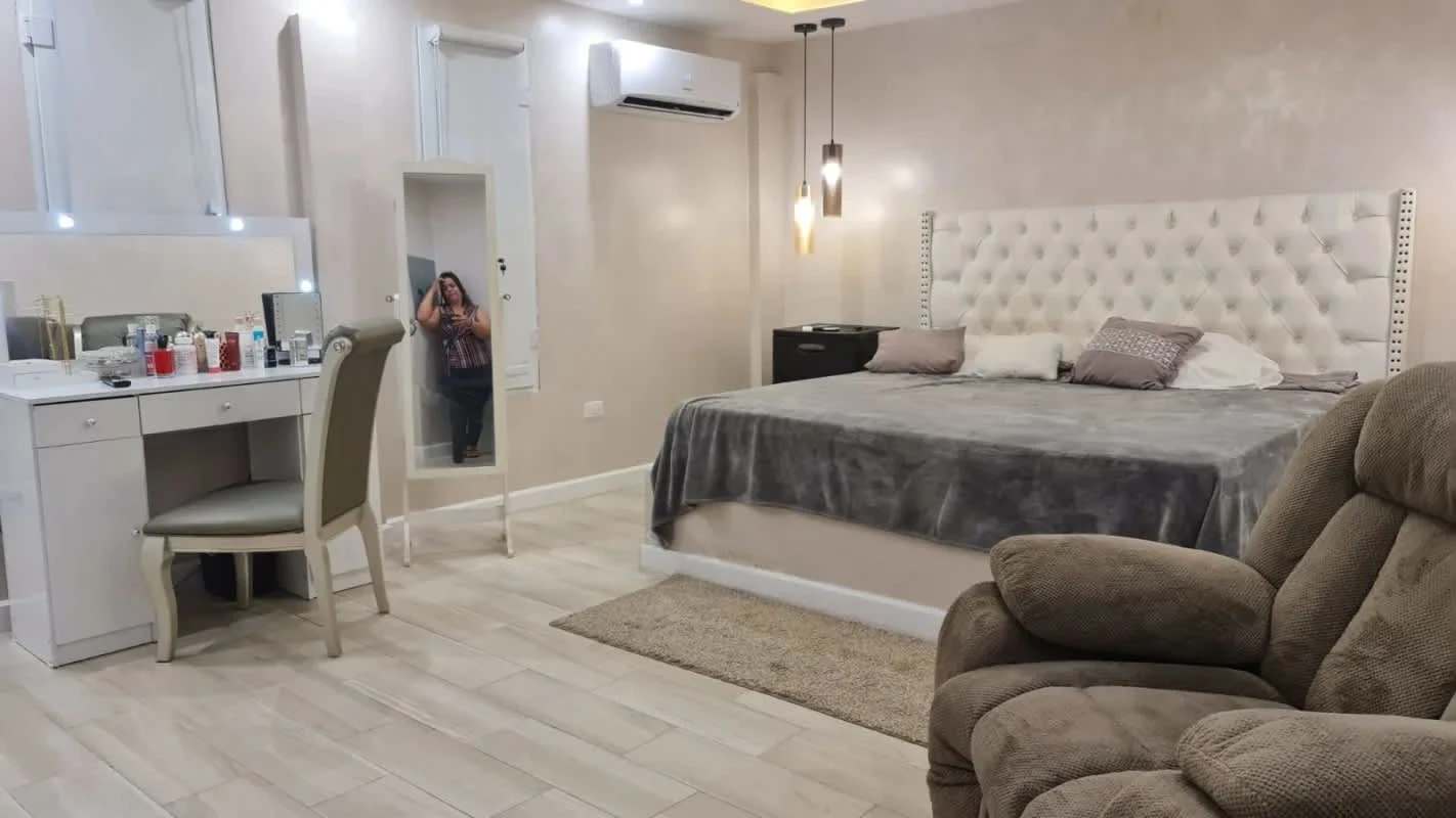 Spacious modern bedroom with headboard, vanity, recliner in Palma de Mayorca Villa Zaita