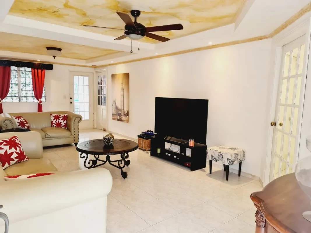 Modern kitchen with red cabinetry, granite countertop, oven Villa Zaita Panama